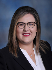 Photo of Molly Herrington, Interim Chief People Officer. Molly is a white female with glasses. She is wearing a black business suit.